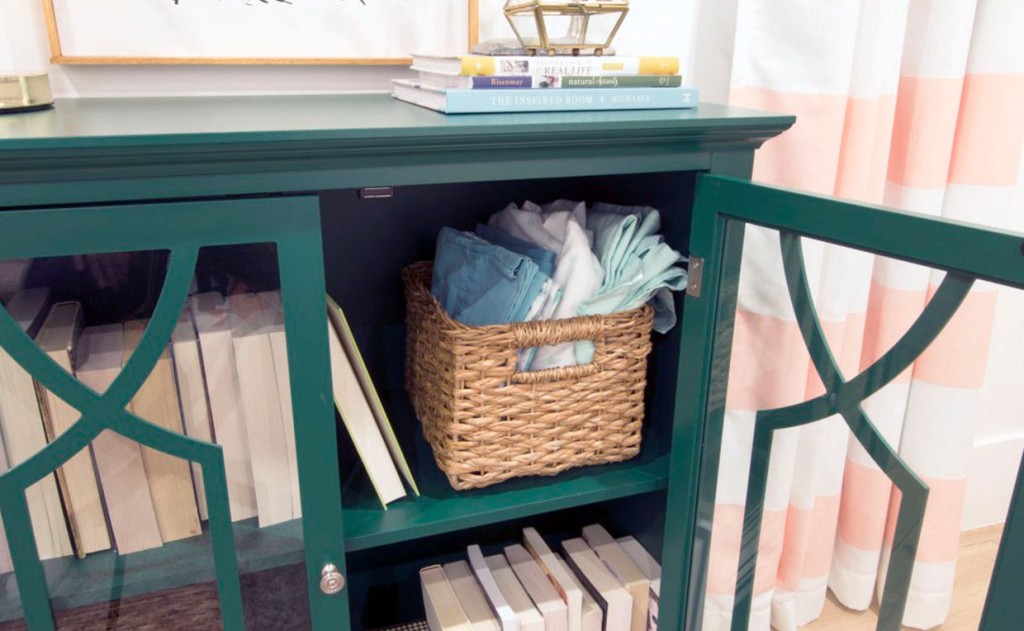 Emerald Green Shoal Creek Display Cabinet with books and bed linens behind doors