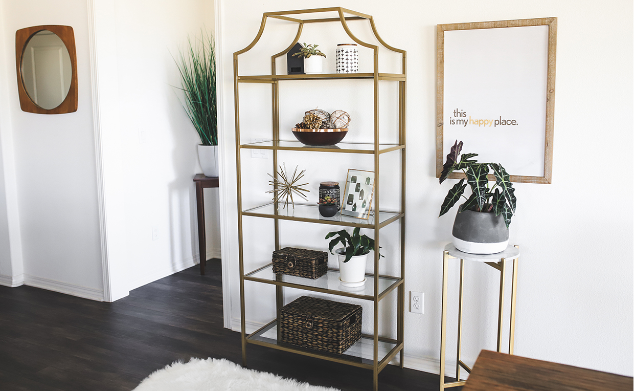 Gold metal and glass tower bookcase in dining room