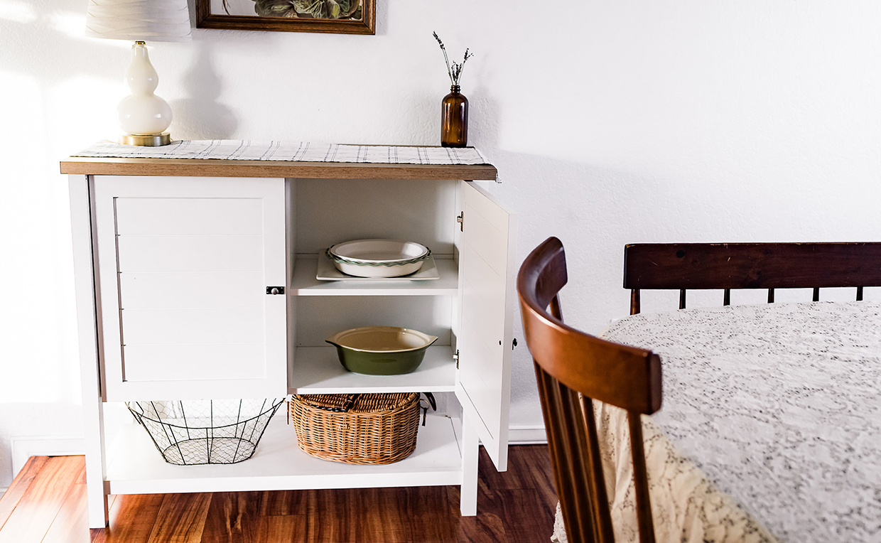 Cottage-style storage cabinet with shelves in dining room