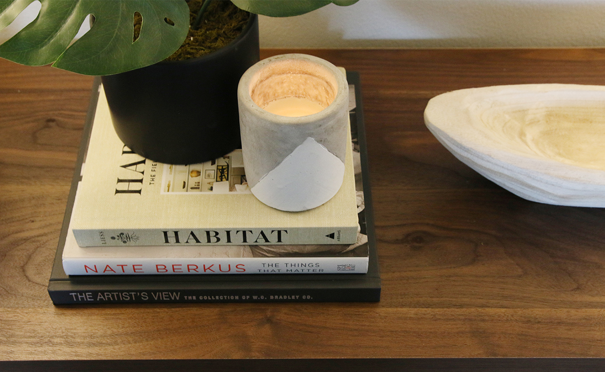 Dresser with books, candle, plant and keyholder